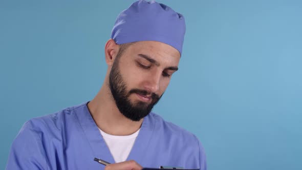 Happy Male Doctor in Scrubs Smiling for Camera alt