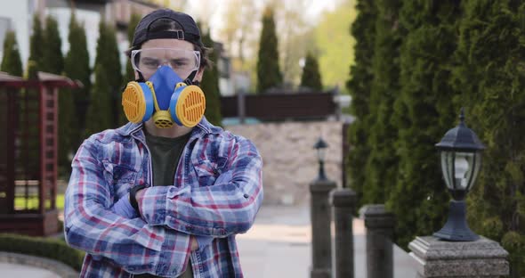 Portrait of Virologist Looking at Camera and Crossing Hands Outdoors alt