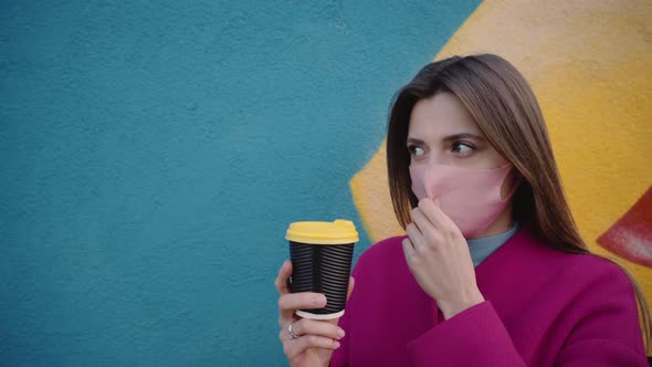 The Girl Took Off Her Mask and Drink Coffee in the Street