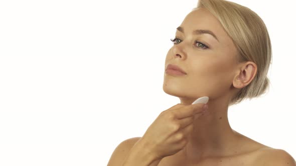 The Well-groomed Woman Is Wiping Her Face with a Cotton Pad alt
