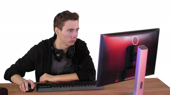 Young Man Gamer Watching Stream Game on White Background alt