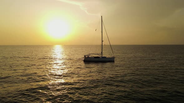 Drone Video of a Yacht Crossing the Water at Sunset
