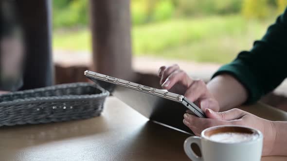 Customer order food and drink, using tablet in a restaurant. Digital menu.