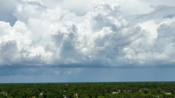 Dark Stormy Clouds Forming on Gloomy Sky Before Heavy Rainfall Over Suburban Town Area alt