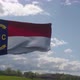 North Carolina Flag on a Flagpole Waving in the Wind Blue Sky Background - VideoHive Item for Sale
