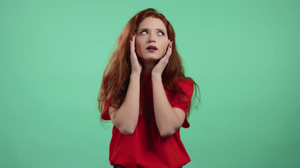 Bored Woman Portrait Her Head is Spinning Around on Green Background alt