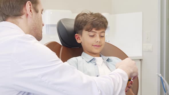 Lovely Little Boy Visiting Dentist for Teeth Examination alt