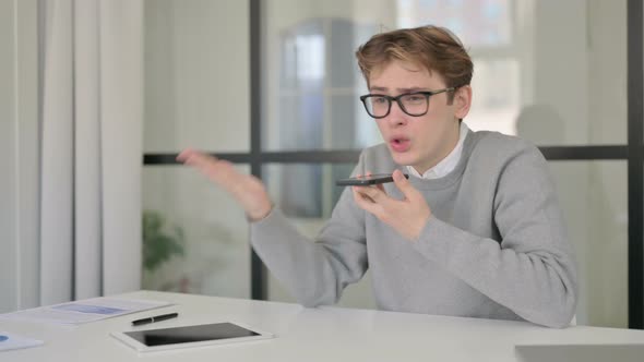 Angry Man Talking on Phone in Modern Office alt