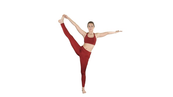 Young woman practicing yoga standing in Utthita Hasta alt