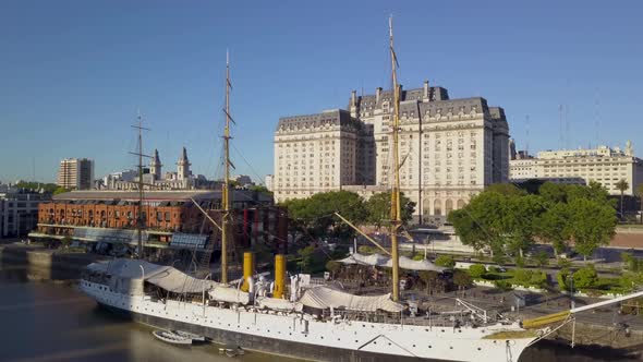 Aerial rising over Sarmiento Frigate and revealing Libertador building on background alt