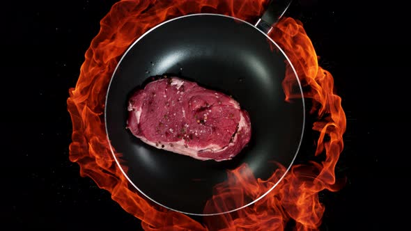 Super Slow Motion Shot of Throwing Beef Meat on Frying Pan and Fire Blast at 1000Fps alt