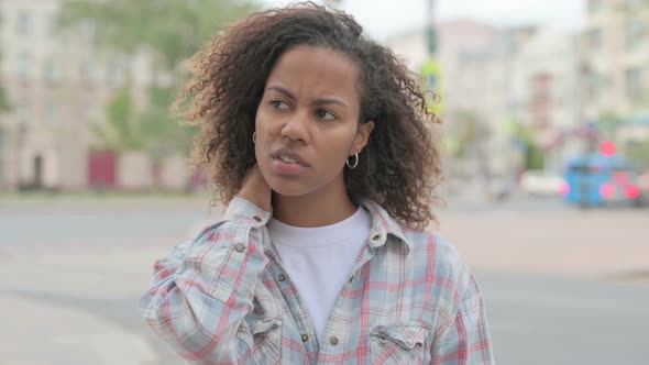 Portrait of Tired African Woman with Neck Pain Outdoor alt