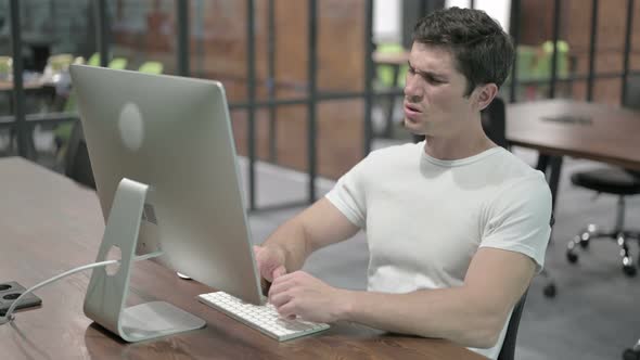 Tense Young Man with Headache at Work alt
