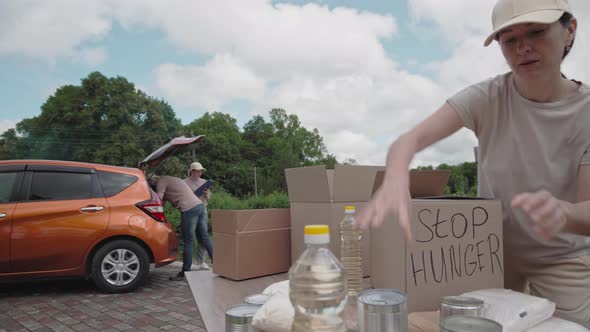 Volunteers loading humanitarian aid into a car