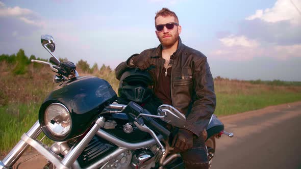 Portrait of a Biker on a Motorcycle Chopper with Sun Glasses