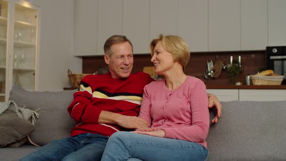 Smiling School Age Multicultural Kids Embracing Grandparents From Behind at Home alt