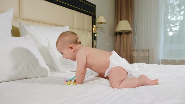 Lovely Baby Girl Playing at Home in Bedroom Looking at Camera Smiling. 9 Months Happy Toddler alt