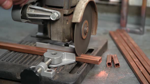 Electric Saw Cuts Copper Profile