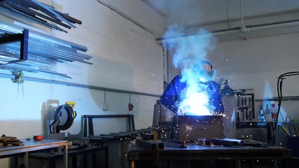 Welder welding a metal alt