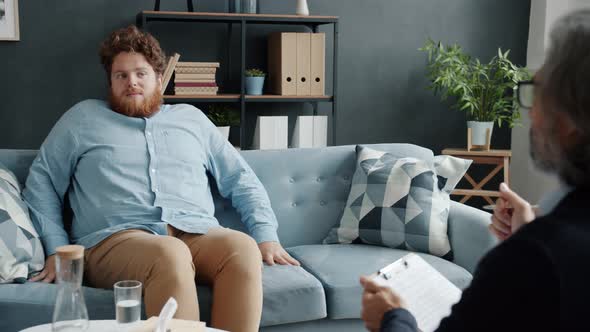 Bizarre Patient Talking to Therapist Gesturing Expressing Emotions During Visit to Doctor's Office alt