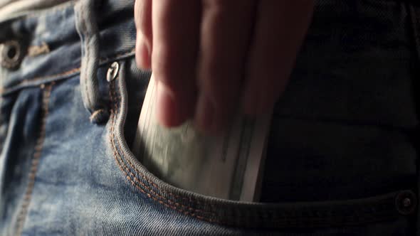 Man Puts Fat Stacked Pile of Fake Cash Dollar Into His Pocket