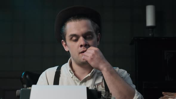 Detective or Gangster or Writer in White Shirt and Suspenders Sits at Table and Prints Something on alt