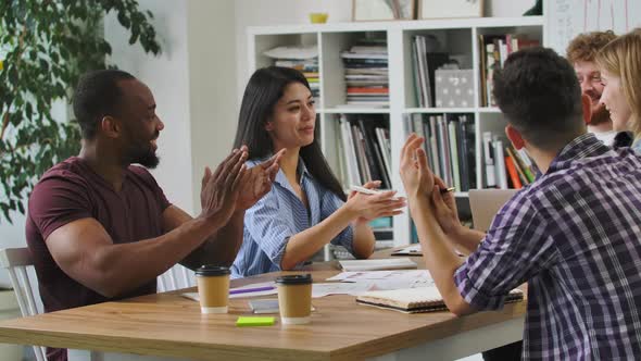 Happy Creative Startups Clap During Corporate Brainstorming Session in Modern Office alt