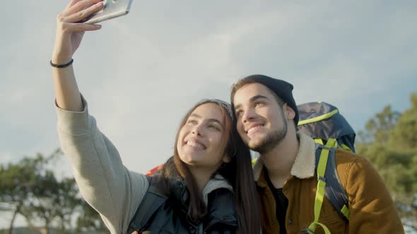 Happy Couple Taking Selfie While Hiking Together