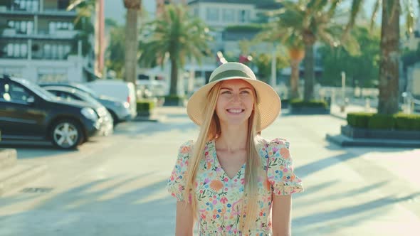 Happy Young Woman in Beautiful Outfit Walking in Port and Smiling