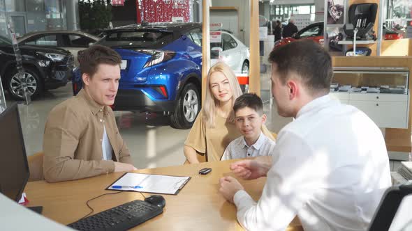 Pleasant Communicable Salesman in Dealership Talk with Clients alt
