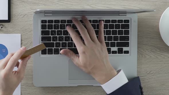 Wealthy Businessman Inserting Number of Gold Credit Card on Laptop, Banking alt