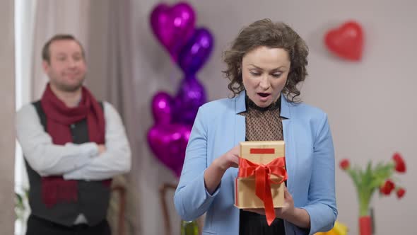 Portrait of Beautiful Brunette Excited Woman Posing with Car Keys Gift for Valentine's As Blurred alt
