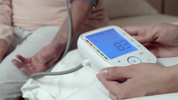 Close up of Readout From Automatic Arm Blood Pressure Monitor With Ideal Blood Pressure
