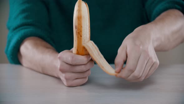 A Man Is Peeling a Ripe Banana alt
