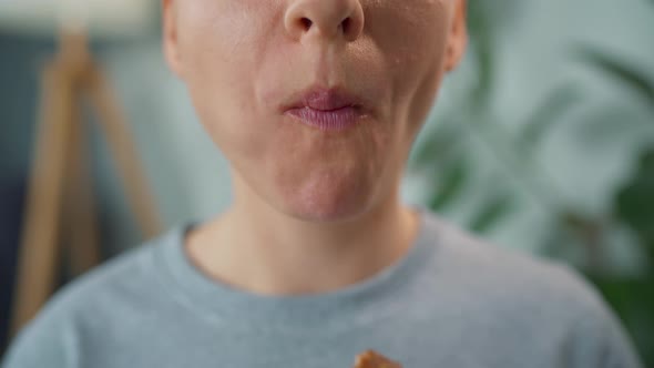 Woman Eating Chocolate Donut with Caramel Sprinkles alt