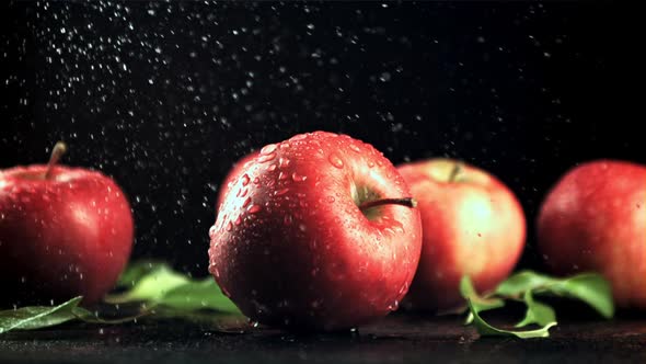 Drops of Water with Splashes Fall on the Red Apples alt