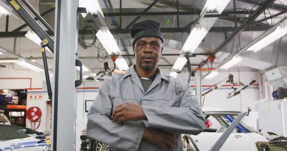 African American male car mechanic crossing his arms and looking at camera alt