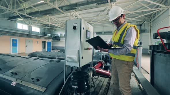 Male Worker Is Managing Indoors Wastewater Facilities alt
