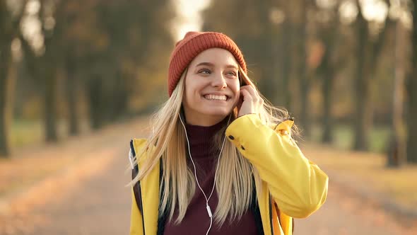 Smiling Woman Walking at The Autumn Park