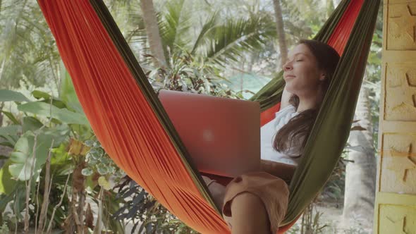 Young Woman Dreaming Hammock Notebook Her Knees Green Tropical Background