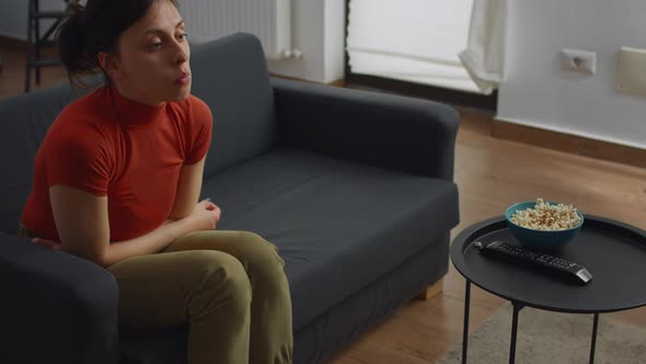Caucasian Woman Sitting Alone on Couch in Living Room alt