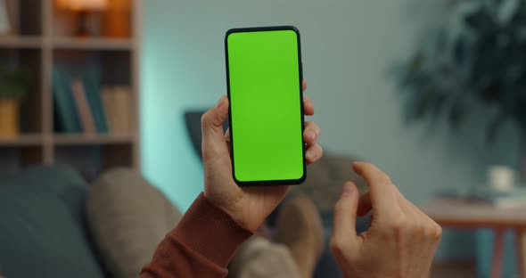 Man Sliding with Finger on Chroma Key Screen of Mobile