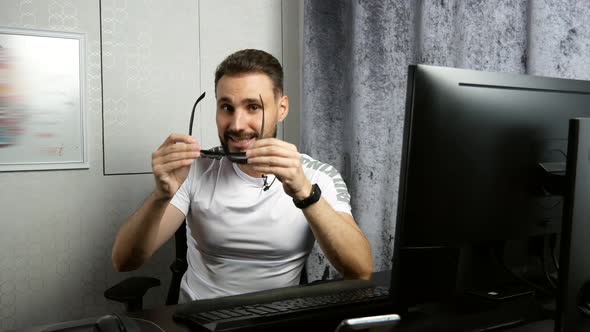 Young Bearded Business Coach Giving Online Lesson About Perforated Glasses for Vision Correction alt