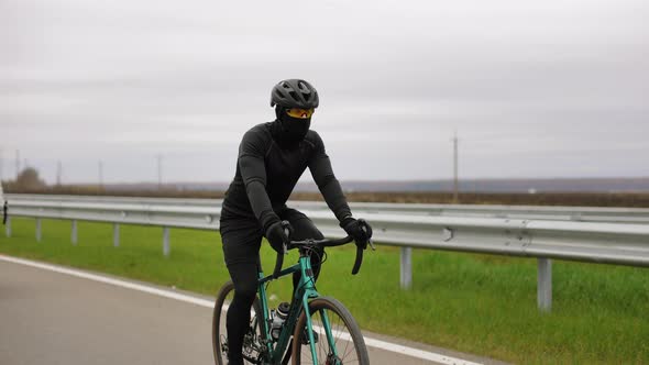 A Cyclist is Training in Cold Weather alt