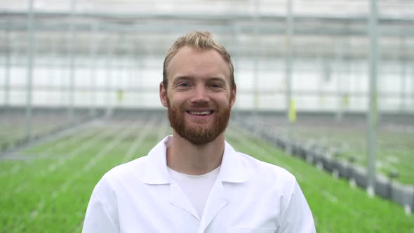 Portrait Man Employee Poses and Stands in Hydroponic Greenhouse During Working Day Spbd alt