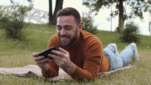 Man Taking Phone Call on Lawn alt