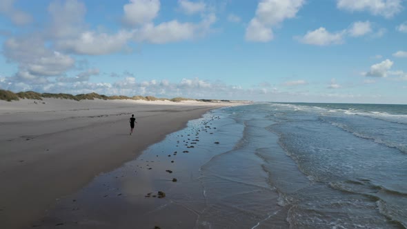Running on Beach Along Coast alt