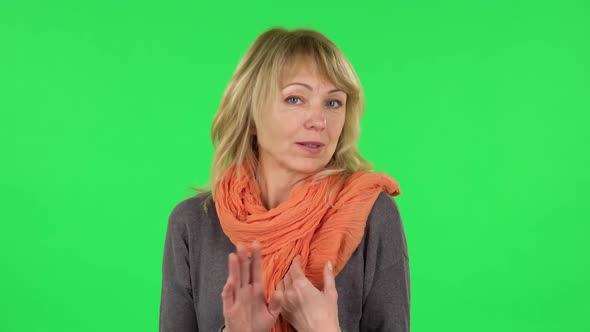 Portrait of Middle Aged Blonde Woman Is Pointing Herself, Say Who Me No Thanks i Do Not Need. Green alt