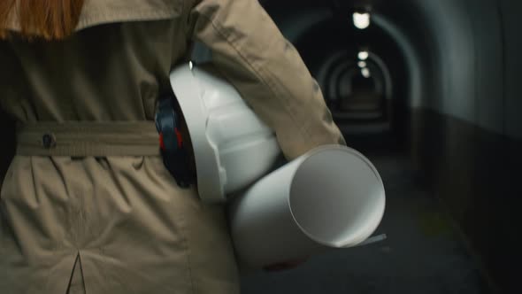 Woman with plan and helmet in tunnel