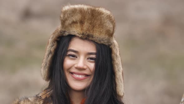 portrait of asian young mestizo woman in ethnic dress posing and sending a kiss to the camera. alt